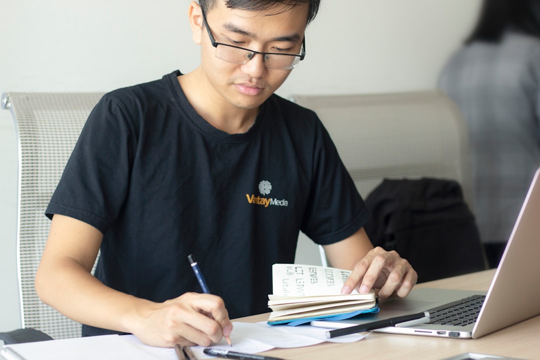 student taking notes during critique session